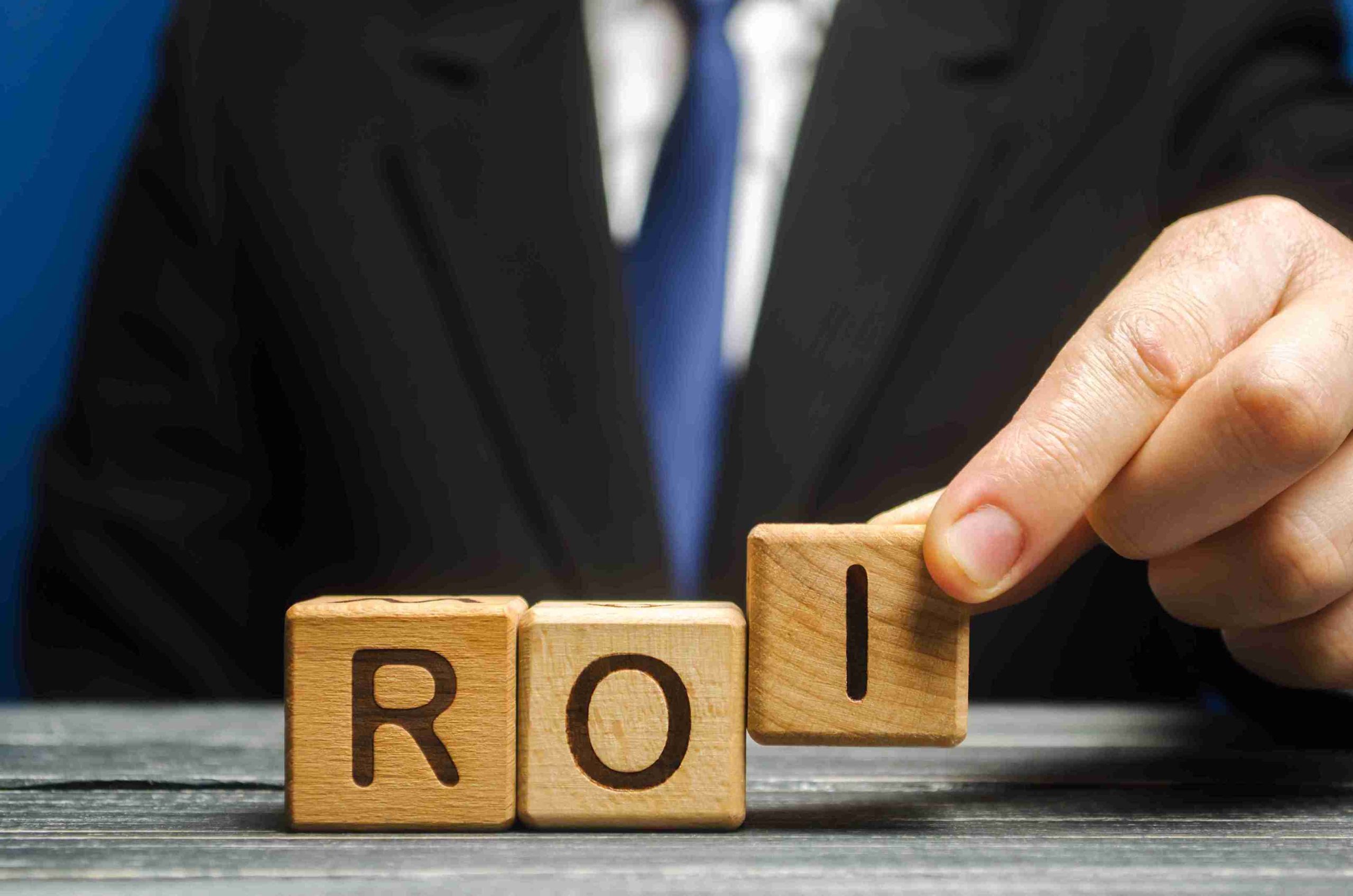 roi-concept-with-wooden-blocks-and-business-attire