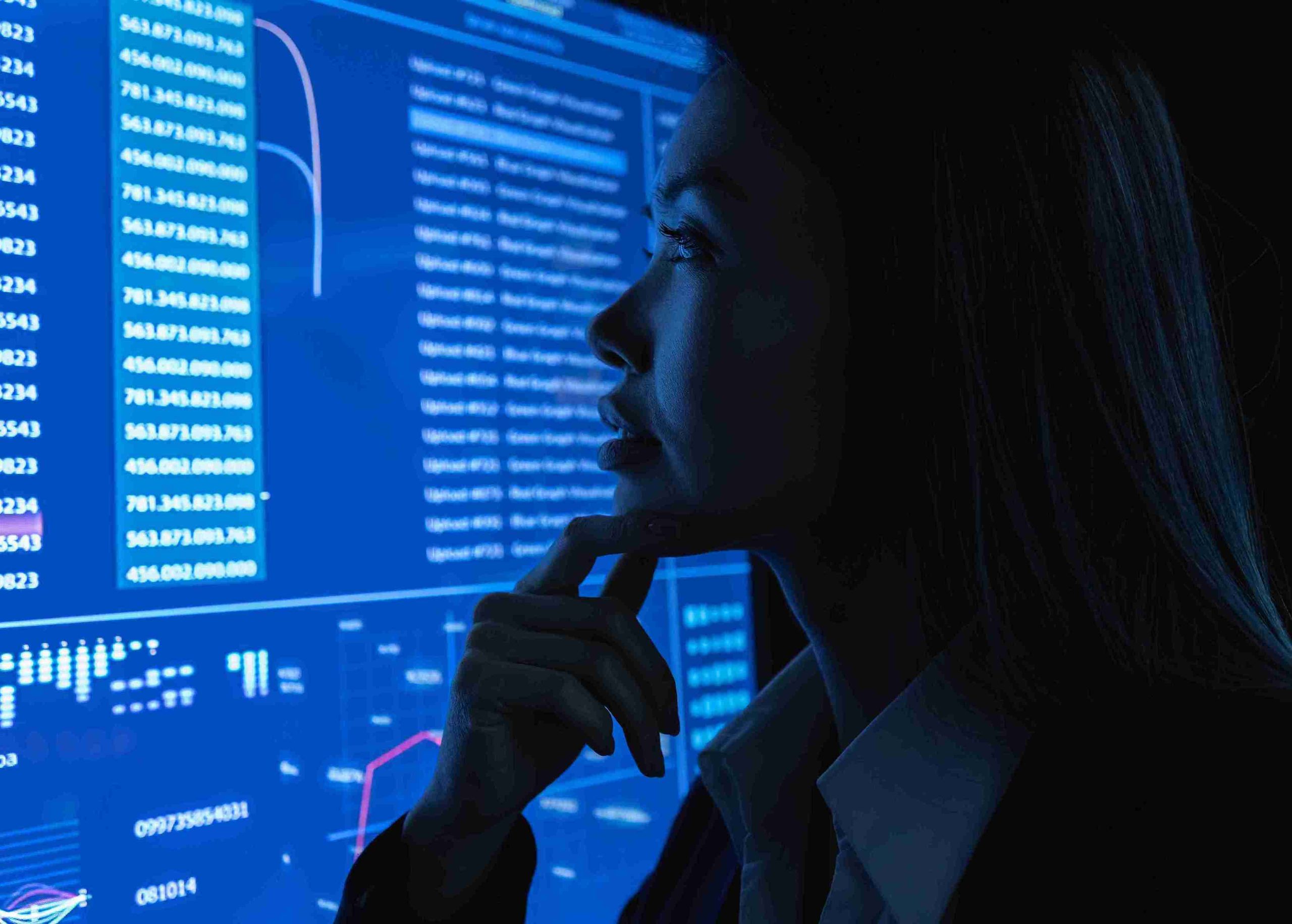 woman-analyzing-data-on-computer-screen-at-night