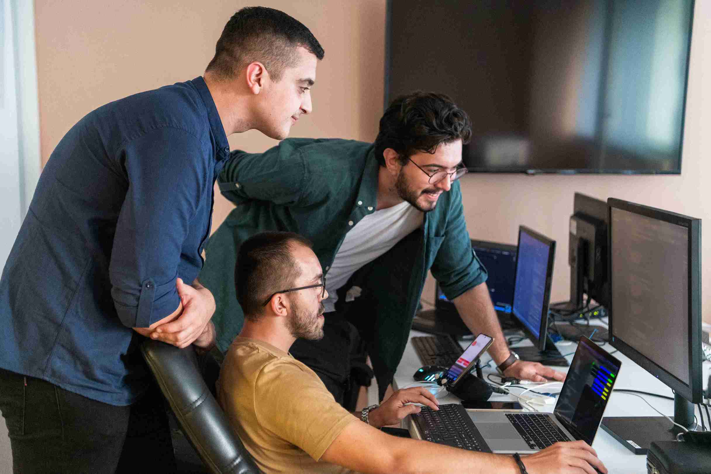 focused-men-collaborating-on-code-at-work