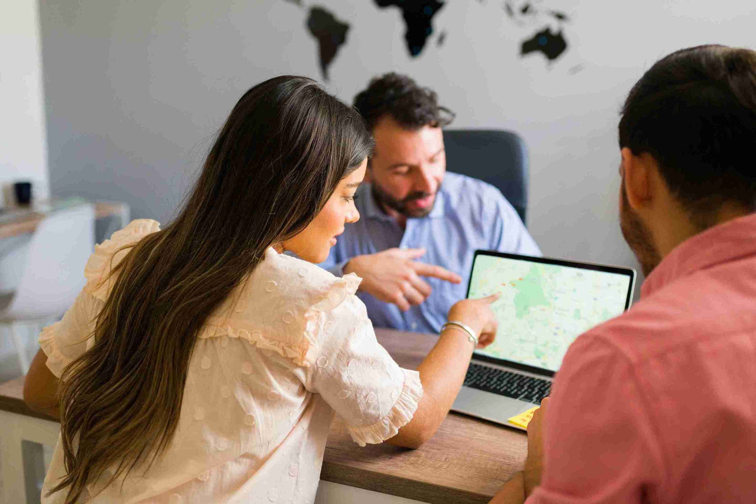 team-collaboration-using-laptop-map-in-office