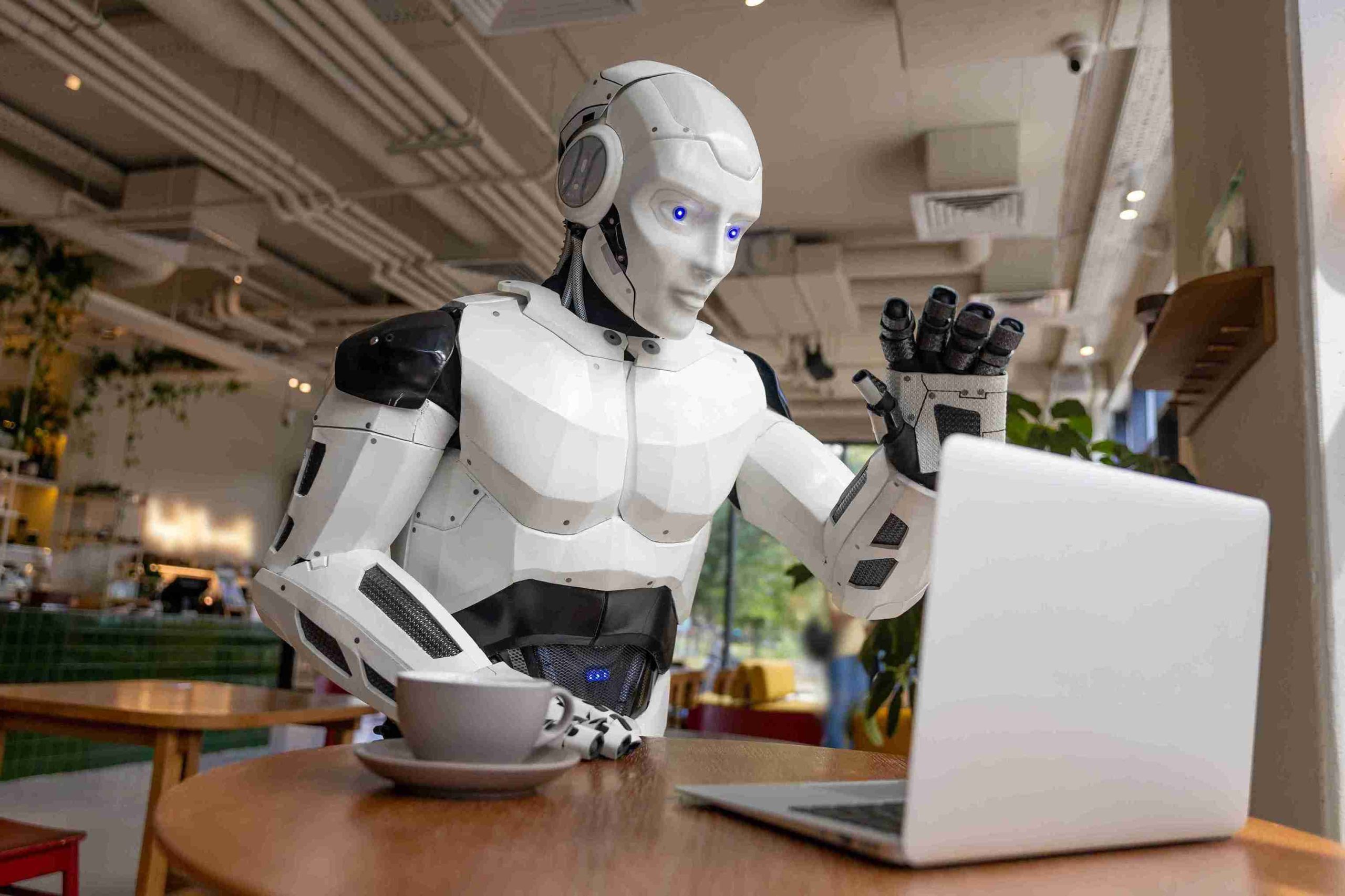 advanced-humanoid-robot-waving-at-laptop-in-modern