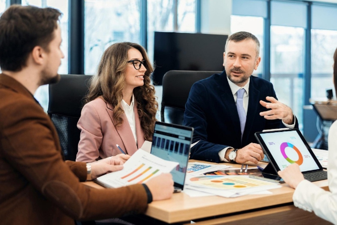 Business professionals engaged in a meeting, collaboratively discussing a strategic business plan. Performance Marketing
