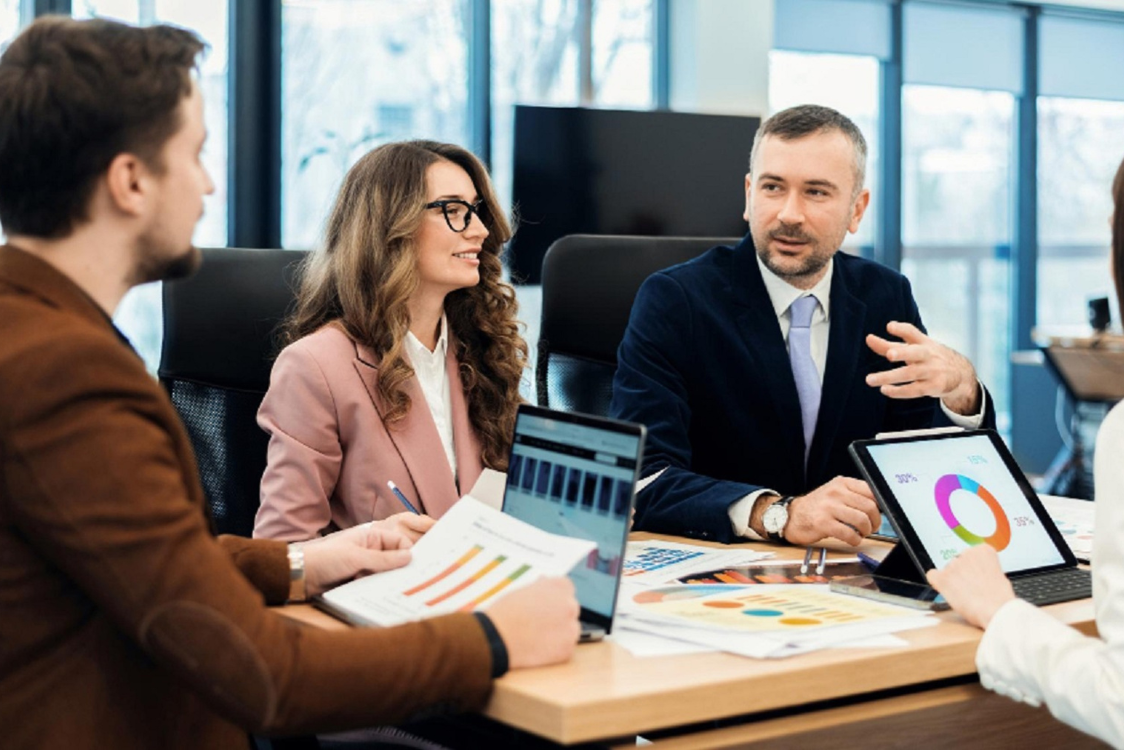Business professionals engaged in a meeting, collaboratively discussing a strategic business plan. Performance Marketing