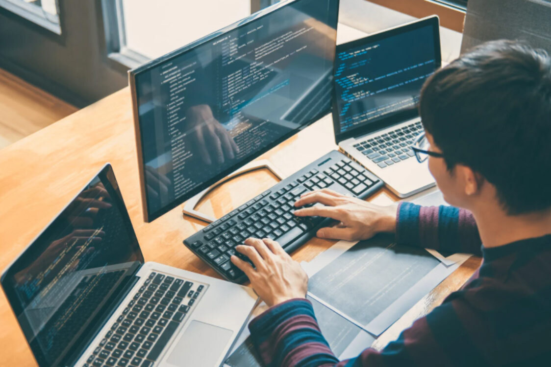 Developer coding a website for AI chatbot website integration.